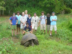 with a tortoise, Isla Santa Cruz, Galapagos