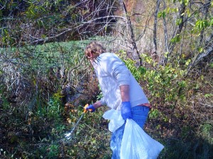 Ryan Davis picking litter out of the brush