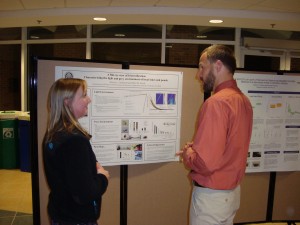 Dr. deHart interacting with students during the poster session