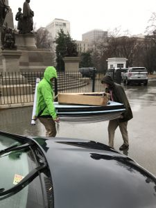 Brant and Jason valiantly transport the easels and poster backings to Dr. Wolyniak's car in a driving rainstorm