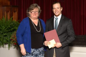 Director of the Office of Academic Success Lisa Burns presents Blake Martin '19 with his award.
