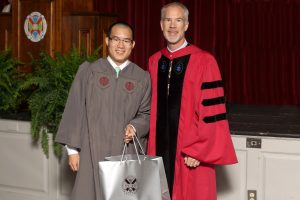 James Lau '17 receives the Hewett Biology award from Chair of Biology Alex Werth