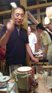 Oshima sensei opening a sake barrel.