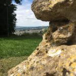 The deteriorated rock of Sham Castle with Bath in the distance.