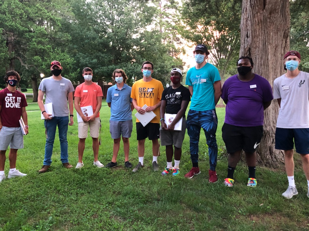 students stand in a semi circle with masks on